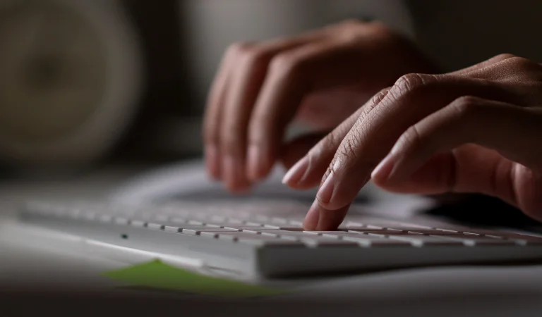 a person typing on a keyboard
