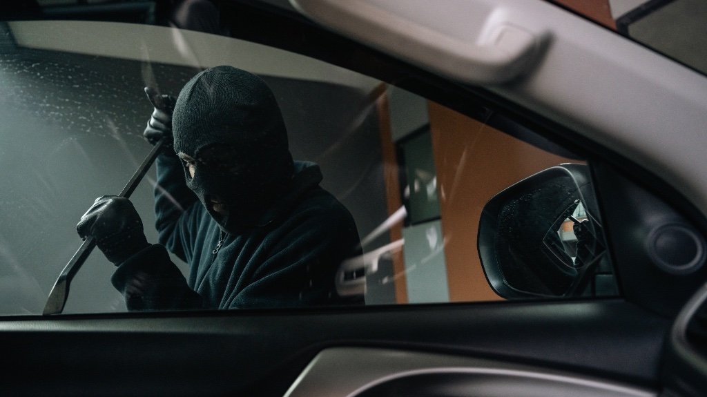 Guy breaking into car