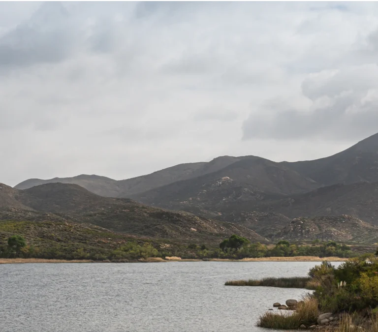 a lake with mountains in the background
