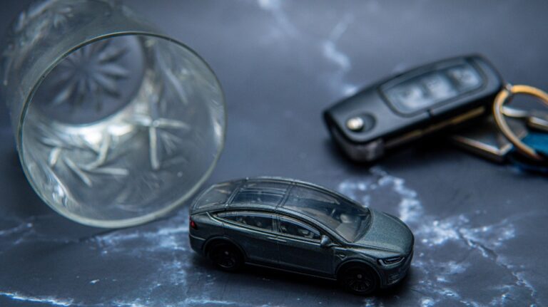 toy car next to glasses with alcohol