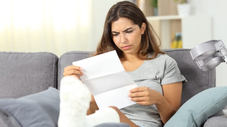 woman with broken leg reading letter