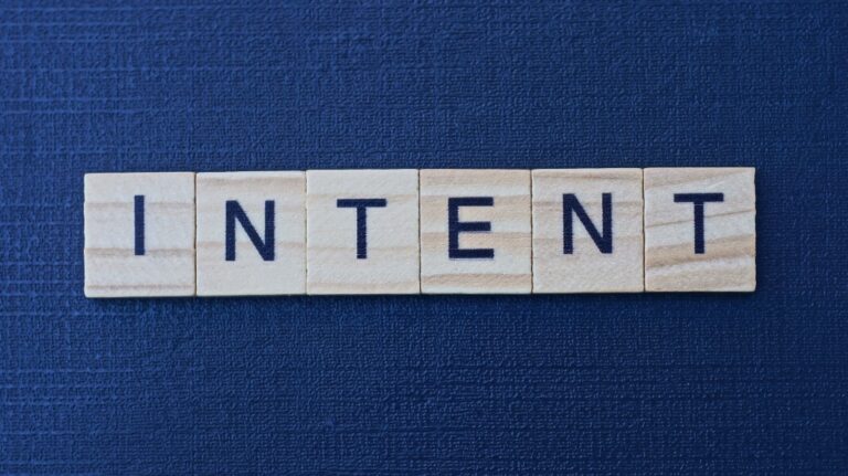 text on word intent from gray wooden letters on a black background