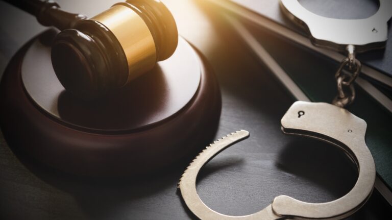 Handcuffs and judge's gavel
